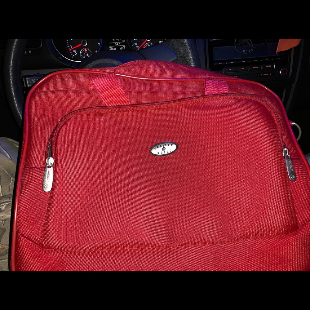 Medium red travel bag on wheels